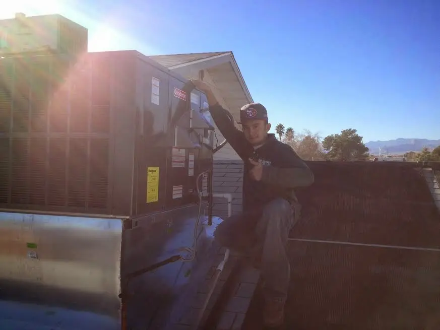 HVAC technician performing Air Duct Cleaning on a rooftop unit in Marina del Rey